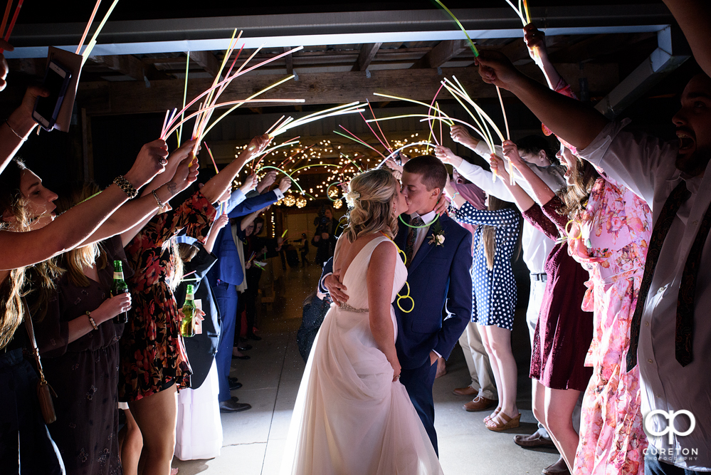 Bride and groom glow stick leave at Greenbrier Farms.