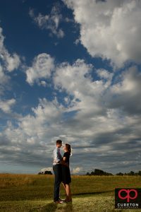 Couple hugging with an epic sky background.