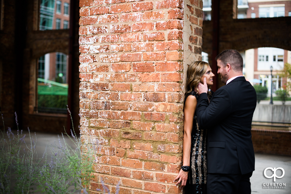 Engaged couple looking at each other at the Wyche Pavilion in Greenville,SC.
