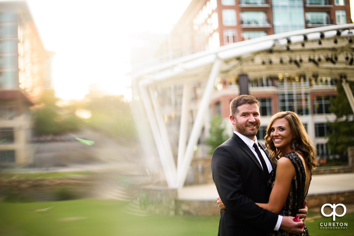 Bride and groom dancing outside the Wyche Pavilion during their downtown Greenville engagement session.
