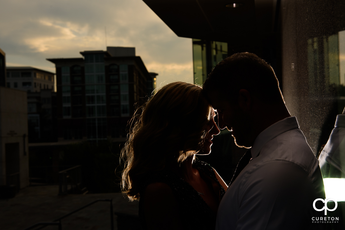 Silhouette of an engaged couple during golden hour.