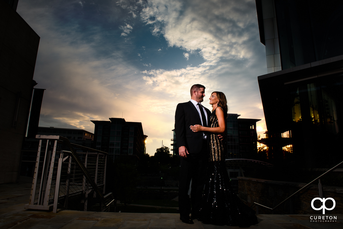 Future bride and groom at sunset in downtown Greenville.