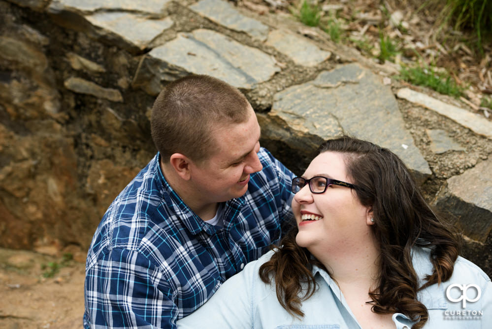 Bride and groom smiling at each other.