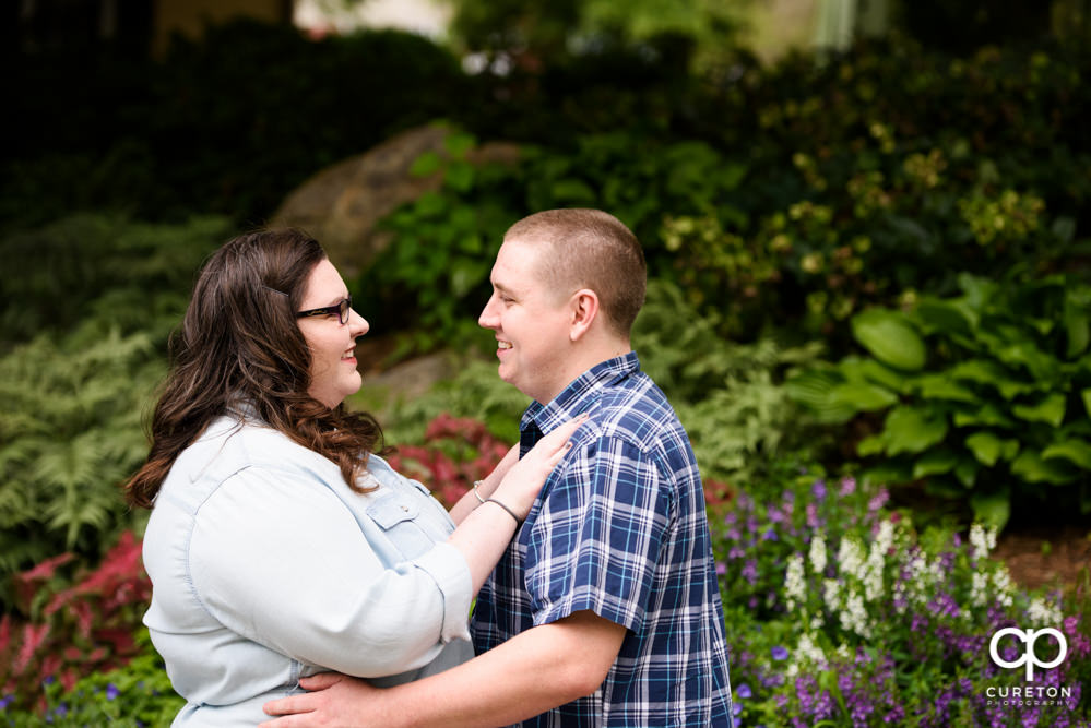 Engaged couple hugging.