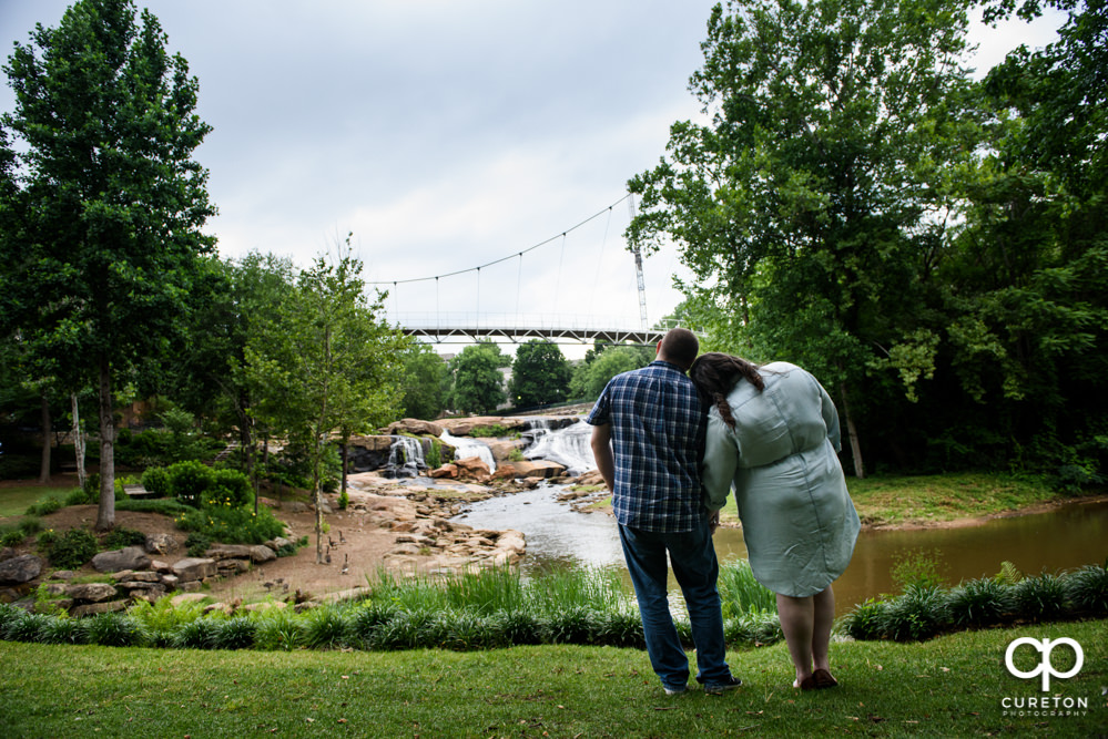 Engaged couple looking at Liberty Bridge.
