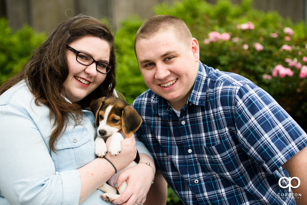 Bride and groom with beagle puppy.