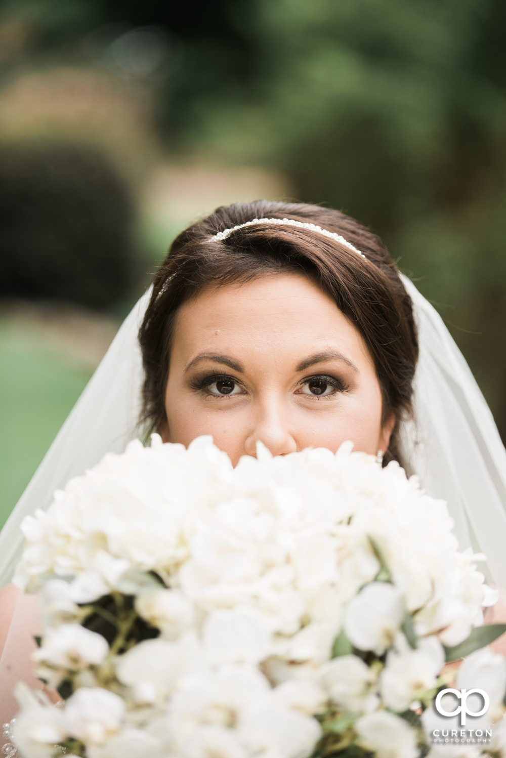 Bride looking over her flowers.