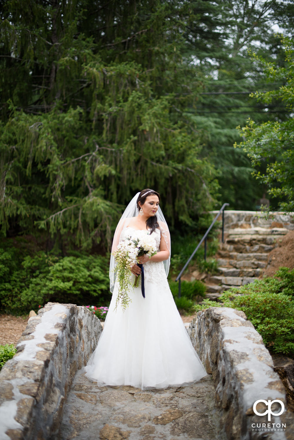 Bride on the stone bridge during her bridal portrait session in downtown Greenville.