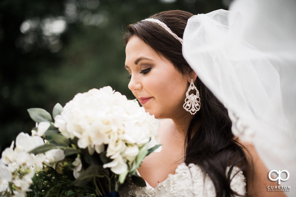 Bride smelling her flowers during her bridal session.