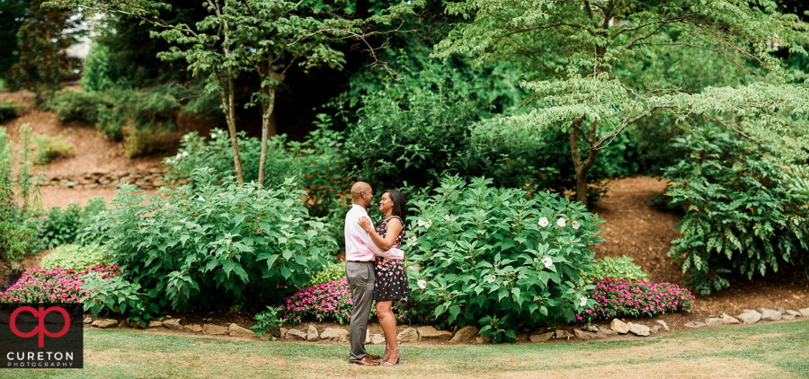 Married couple dancing during their anniversary photo session in Greenville,SC at the Rock Quarry Garden..