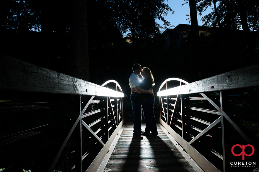 Engaged couple on the bridge at Falls Park.