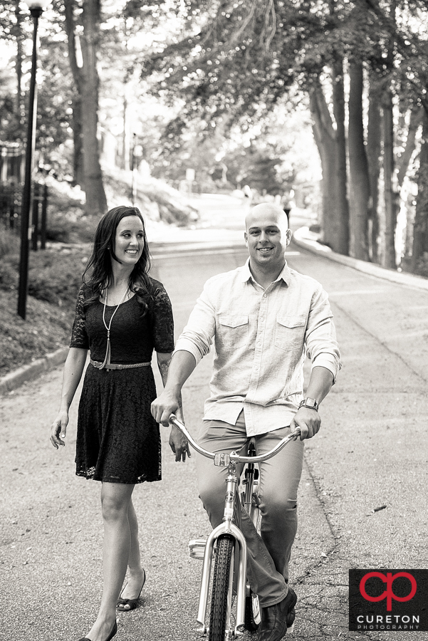 Future groom and bride on vintage bicycle in downtown Greenville,SC.