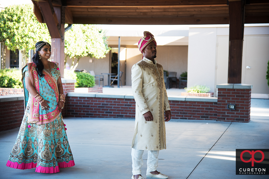 Indian bride and groom at their first look before their wedding.