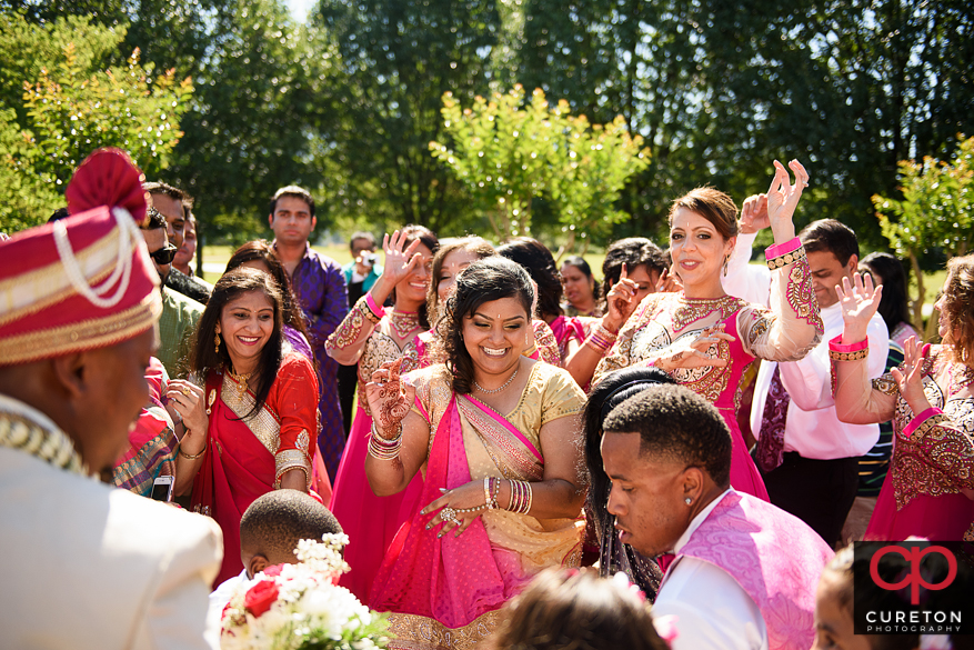 The bride and groom's families dancing during the Baraat before the Indian wedding in Greenville,SC.