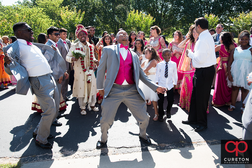 The bride and groom's families dancing during the Baraat before the Indian wedding in Greenville,SC.