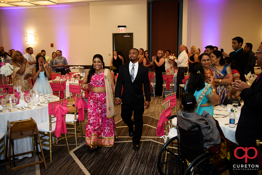 Indian bride and groom making an entrance into the wedding reception at Embassy Suites Greenville.