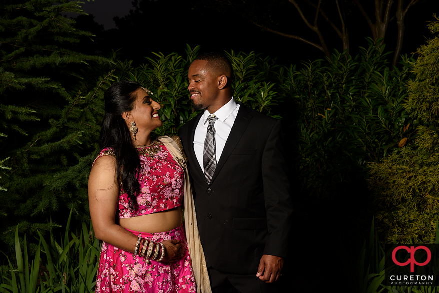 Bride and groom posing outside Embassy Suites Greenville during their wedding reception.
