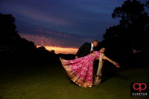 Indian bride and groom sunset portrait on the golf course.