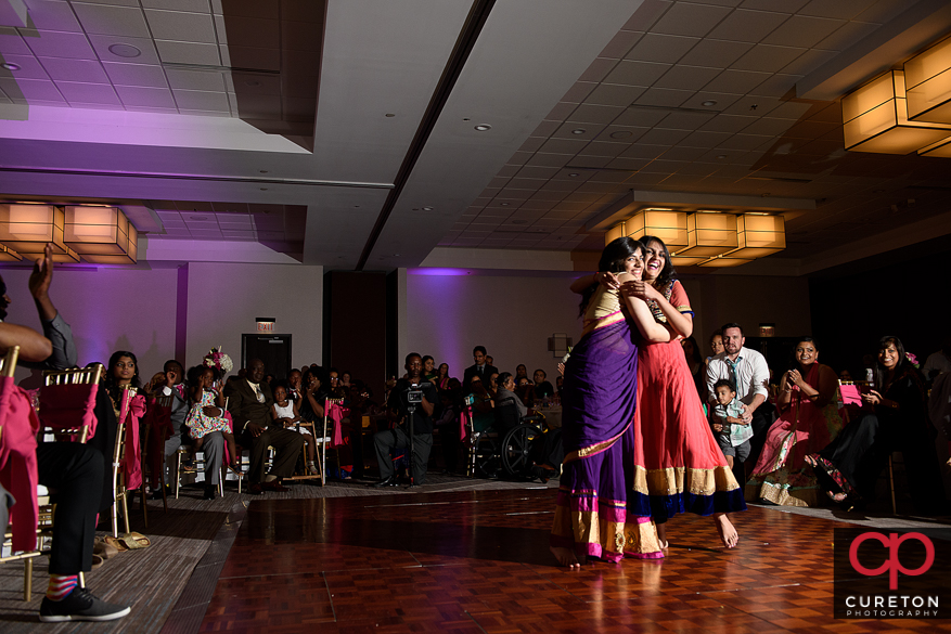 Family members performing for the bride and groom at the Indian Wedding Reception.