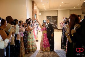 The bride and groom leaving their Indian wedding reception at Embassy Suites in Greenville,SC through a sea of bubbles.