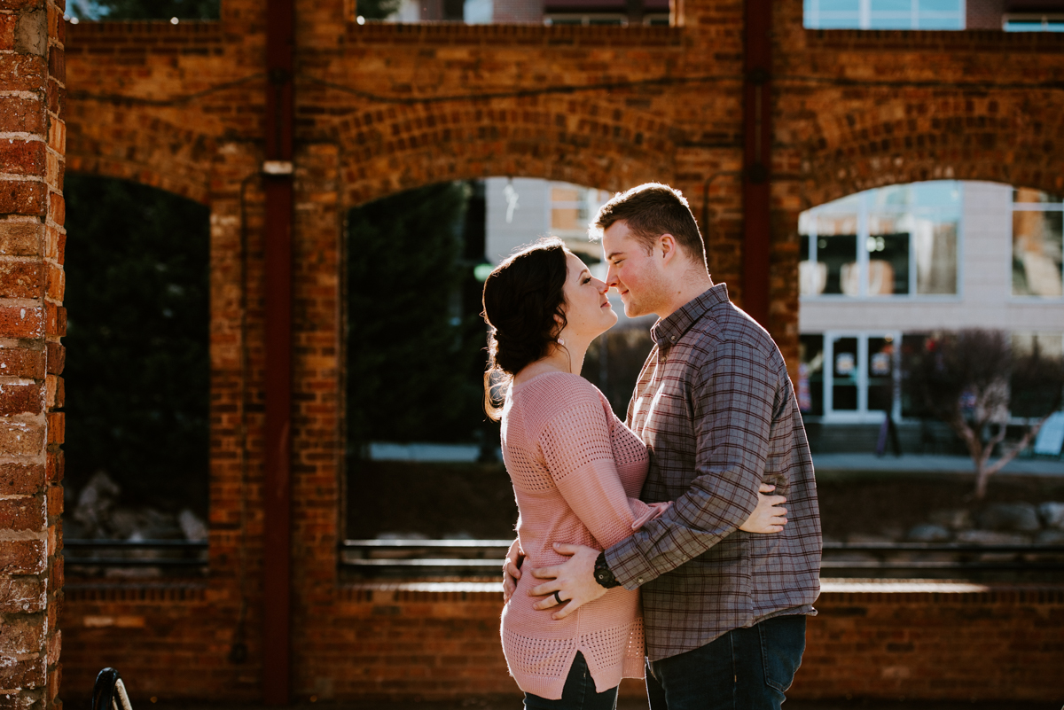 Couple snuggling during their January Engagement Session in downtown Greenville,SC.