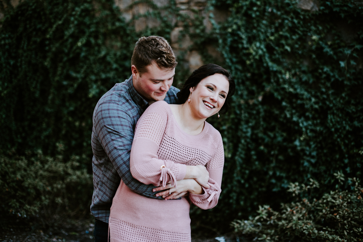Bride and groom laughing during an engagement session in January.