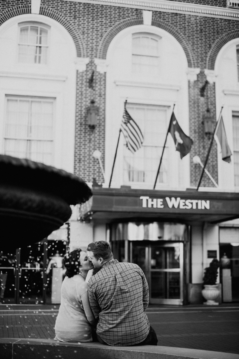 Bride and groom kissing in front of the Westin in downtown Greenville.