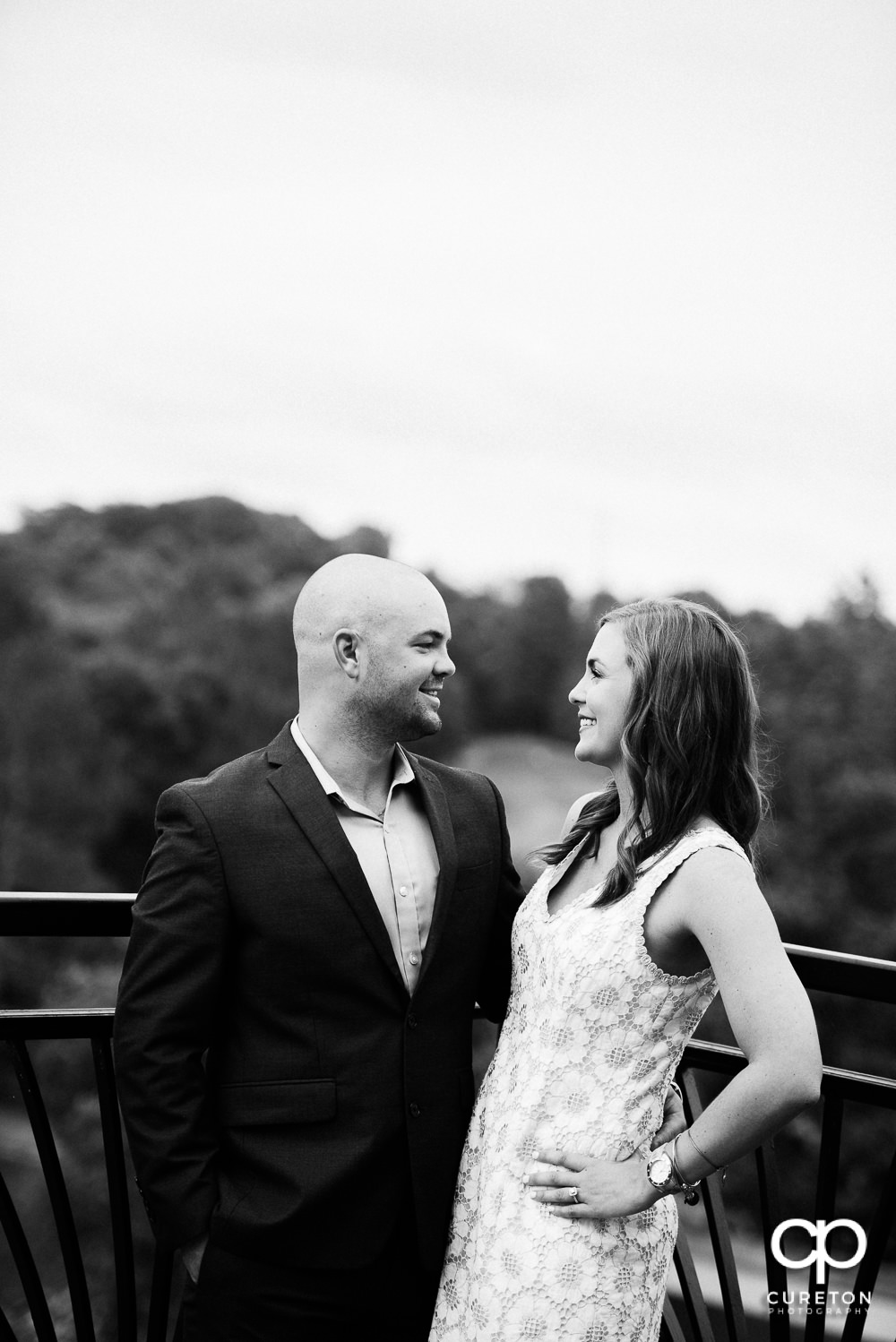 Bride and groom looking at each other at their wedding rehearsal dinner at the Thornblade Country Club in Greenville , SC .