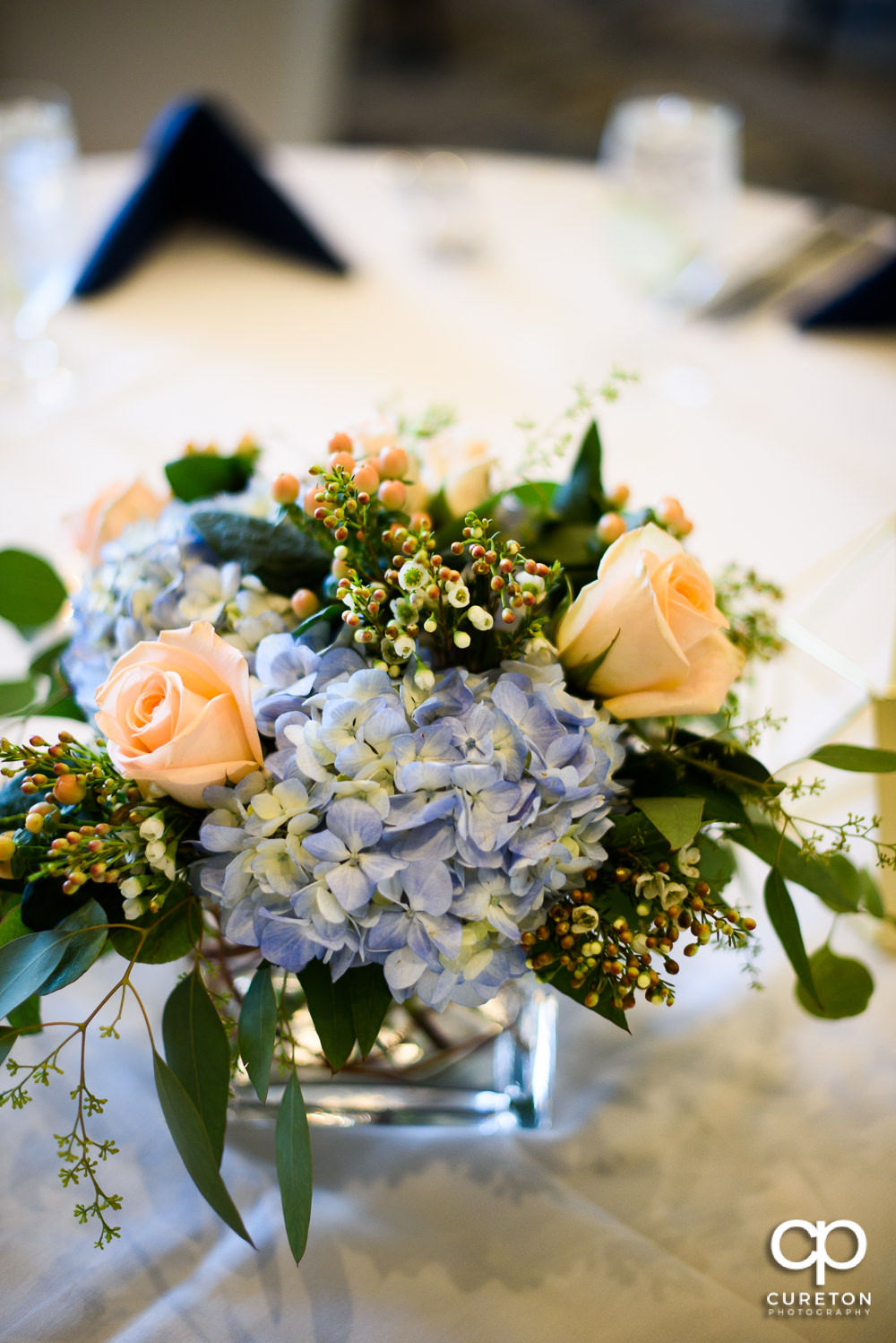 Floral centerpieces at the wedding rehearsal dinner at the Thornblade Country Club in Greenville , SC .