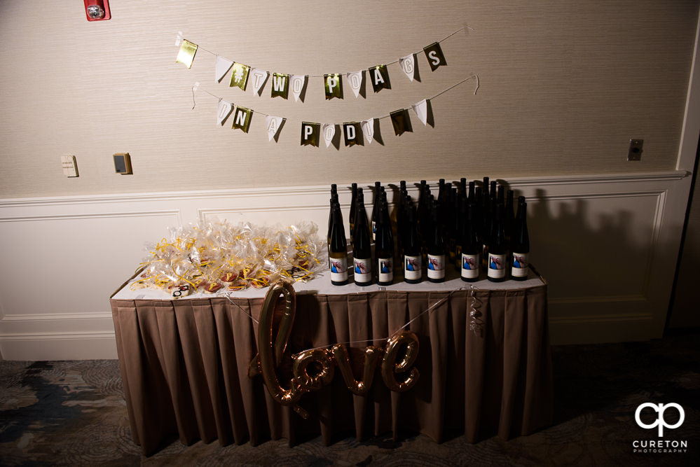 Wine bottles and favors at the wedding rehearsal dinner.