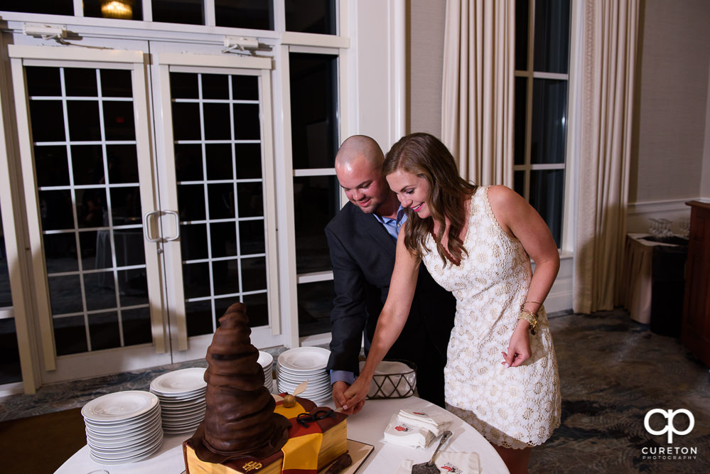 Bride and groom cutting the rehearsal cake.