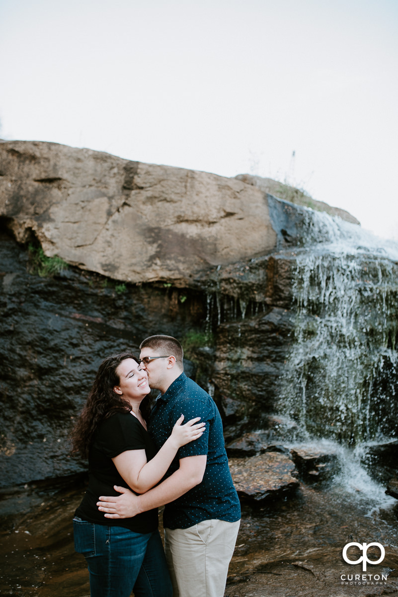 Future husband and wife dancing in Falls Park spring engagement session in downtown Greenville ,SC.