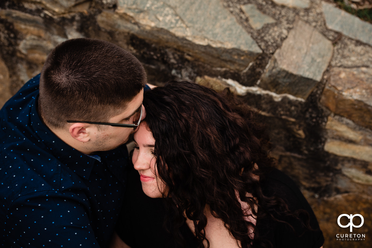 Future bride getting kissed on her forehead.