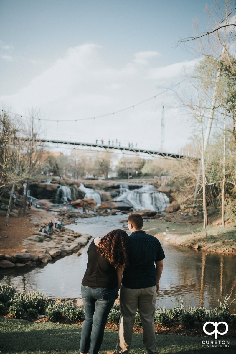 Bride and groom looking at the bride in downtown Greenville,SC.