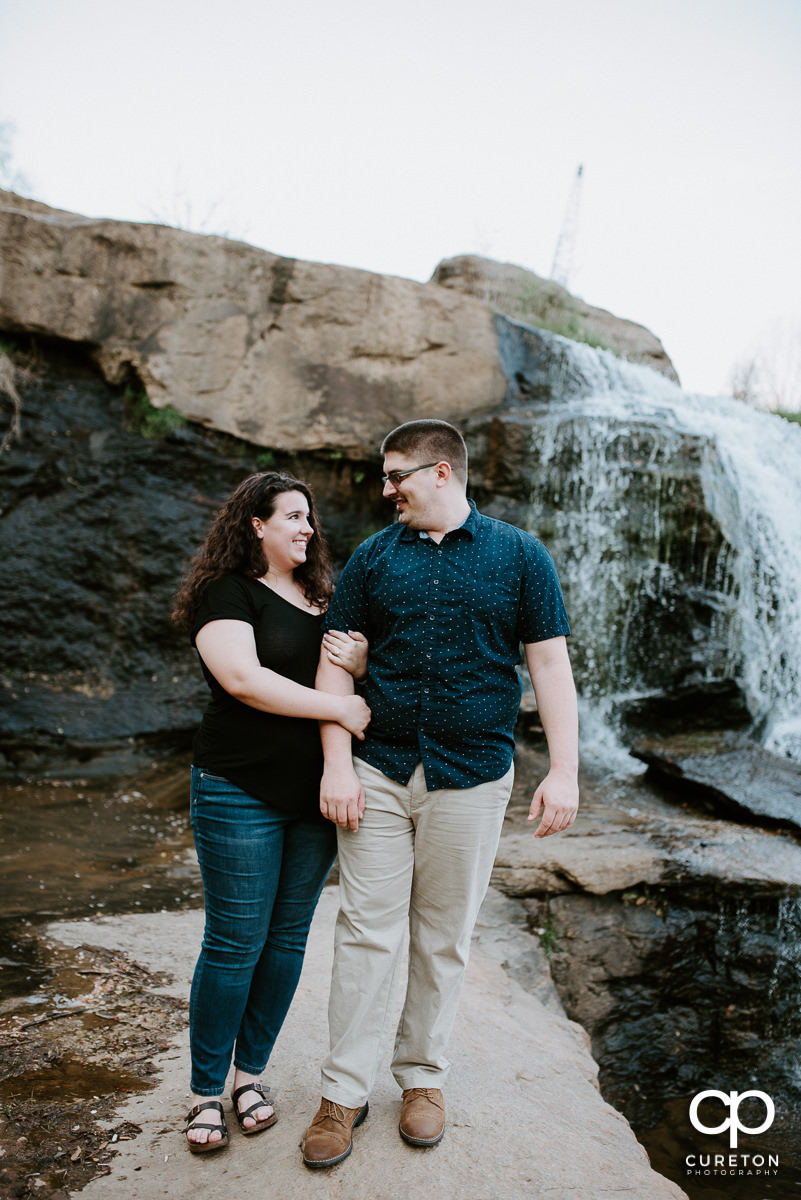 Engaged couple on the rocks in Falls Park.