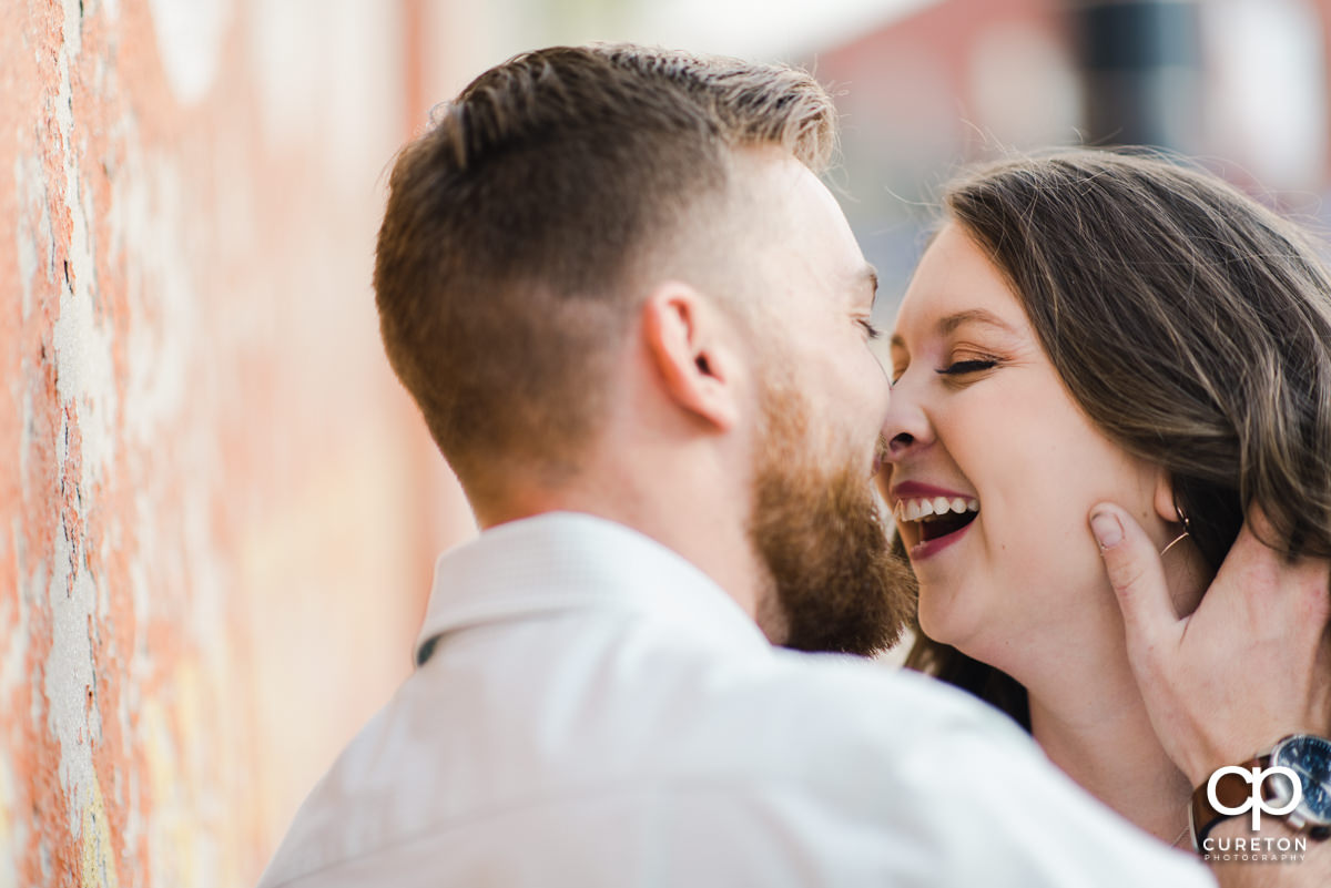 Woman laughing at her husband during a Greenville,SC anniversary session.