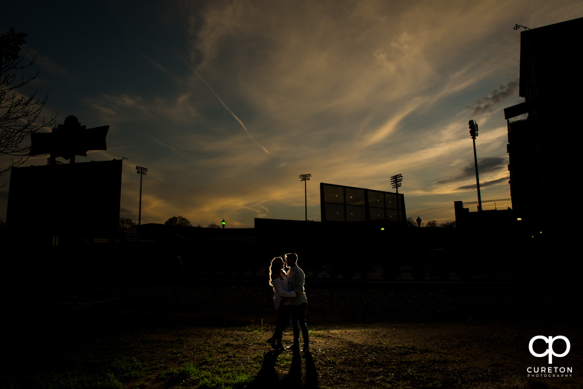 Married couple dancing in front of Fluor Field during a Greenville,SC anniversary session.
