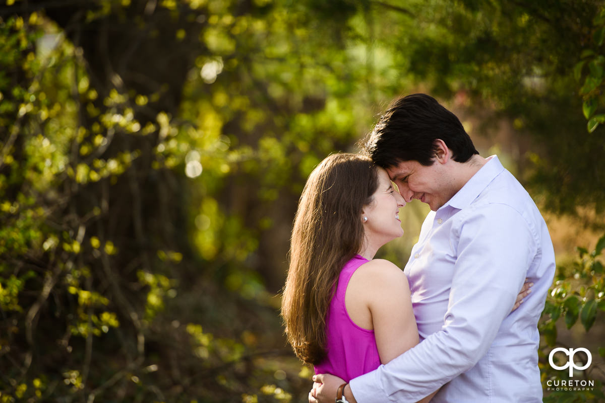 Engaged couple nose to nose in Greer City Park.