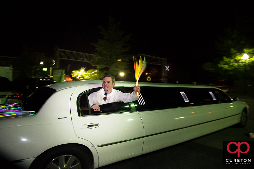 Groom hanging out of the limo