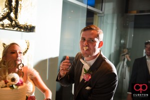 Groom with cake on his face.