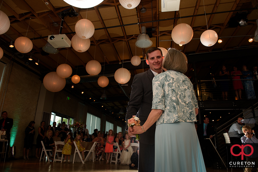 Groom and his mother dancing.