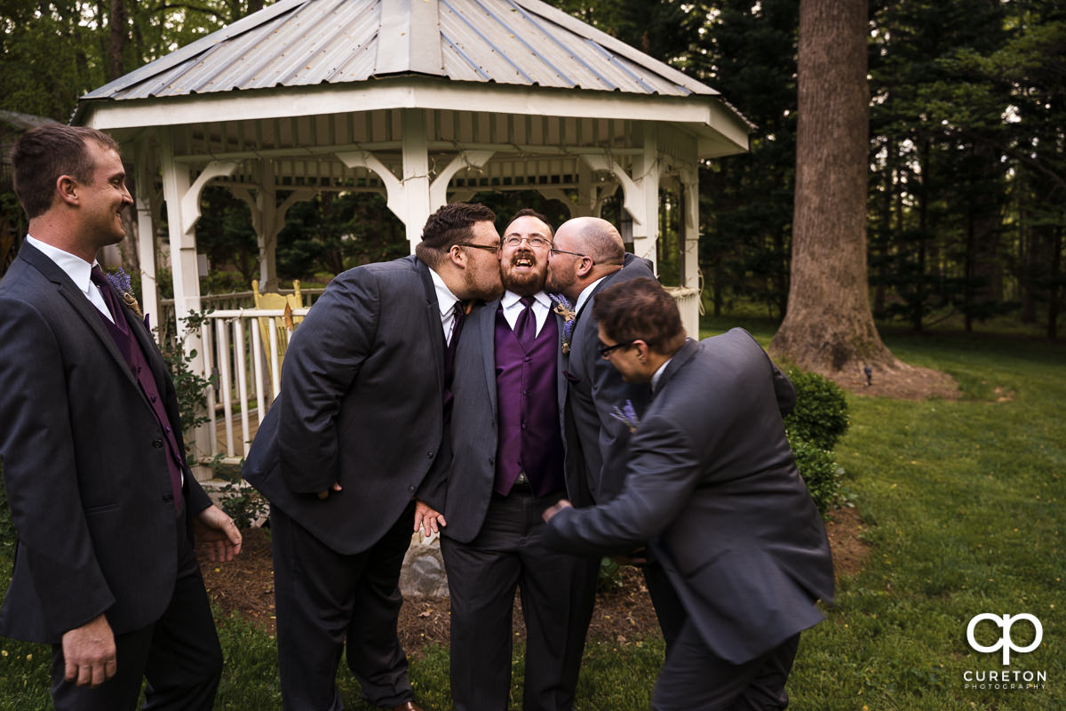 Groomsmen attacking the groom before the wedding at The Grove at Pennington.