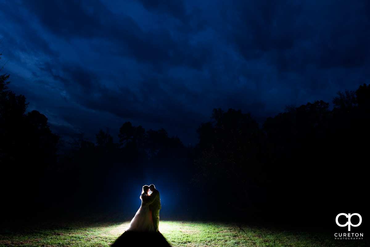 Bride and groom in the field after their rustic wedding at The Grove at Pennington.