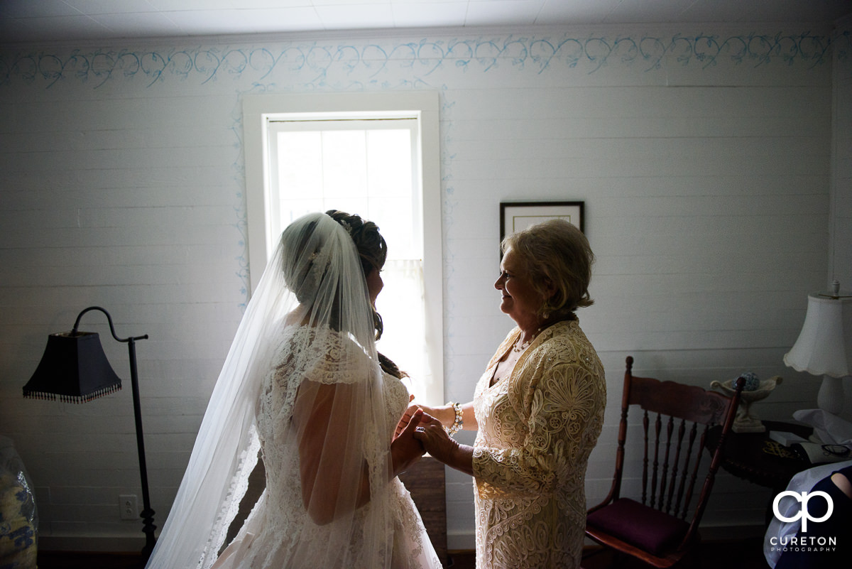 Bride and her mother sharing a moment before the wedding ceremony.