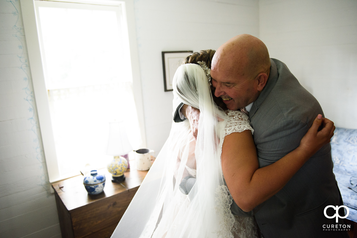 Bride hugging her father.