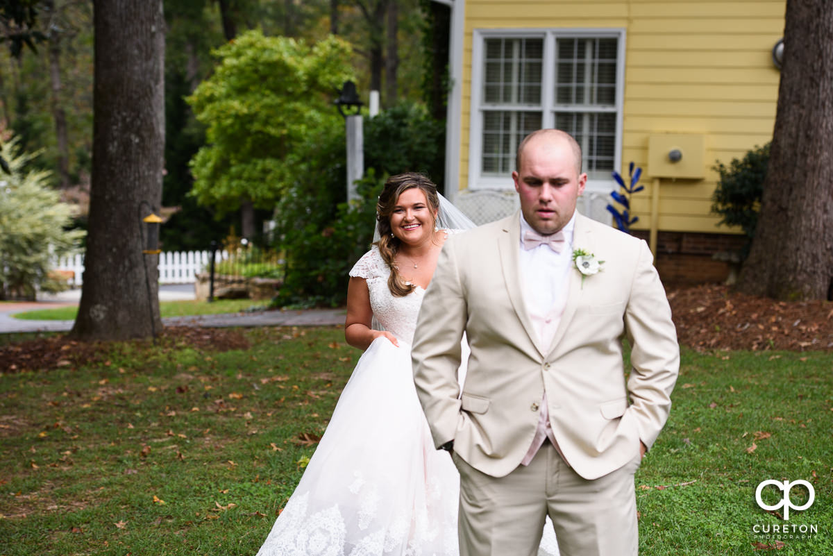 Bride sneaking up on the groom at their first look.