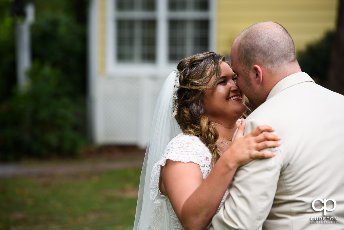 Bride and groom standing close to each other.