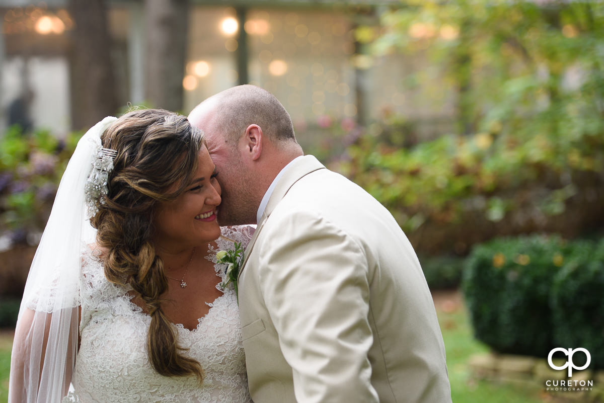 Groom making his bride laugh.