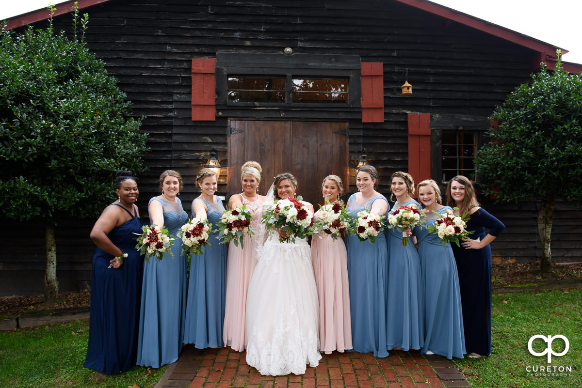 Bride and bridesmaids in from of the Grove at Pennington.