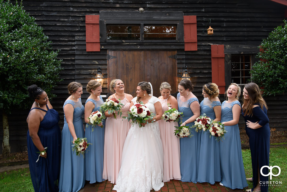Bridesmaids talking an laughing together before the wedding at The Grove at Pennington.